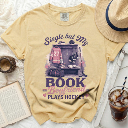 Yellow t-shirt with "Single but My Boyfriend Plays Hockey" graphic.