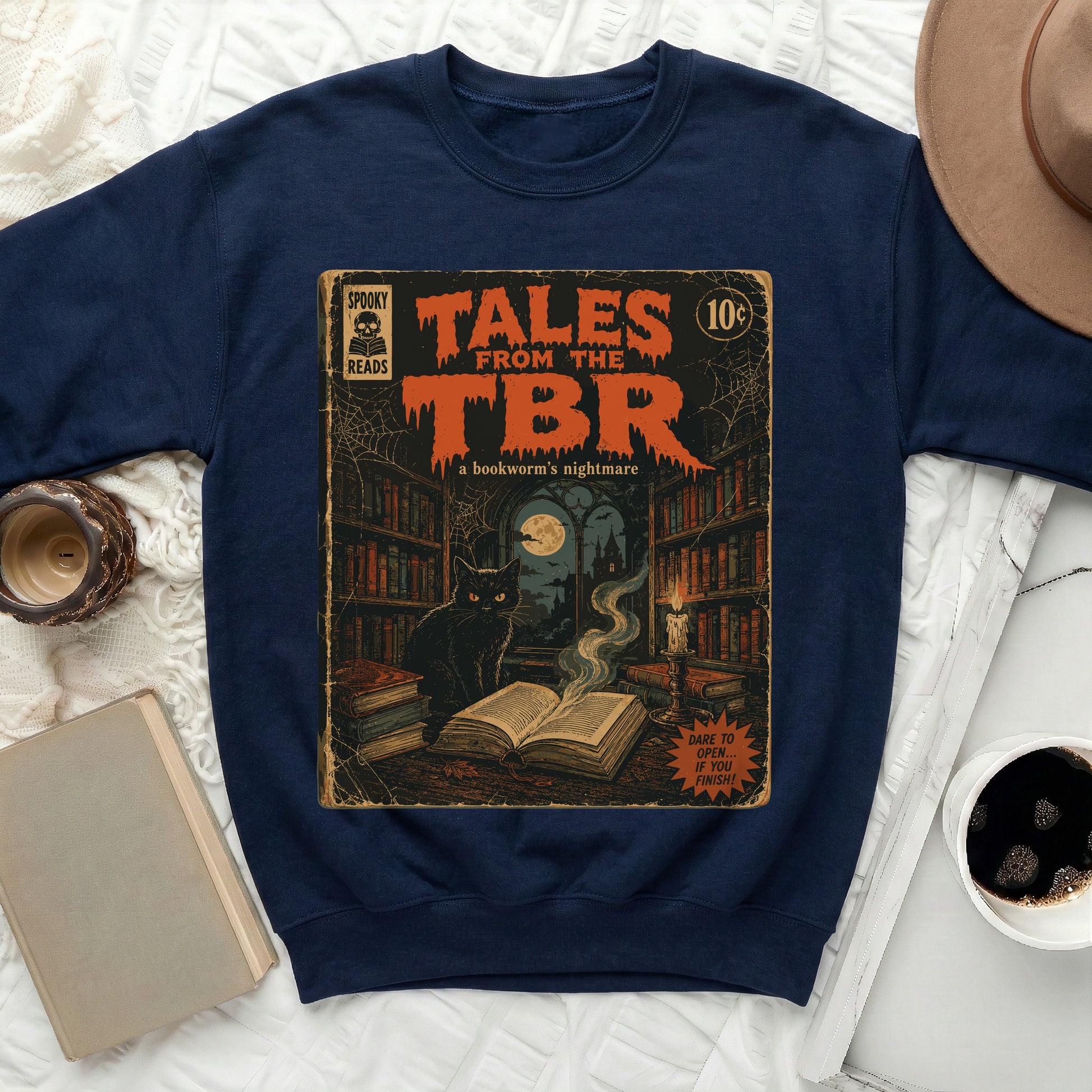 Navy sweatshirt with "Tales from the TBR" graphic featuring a black cat and spooky library.