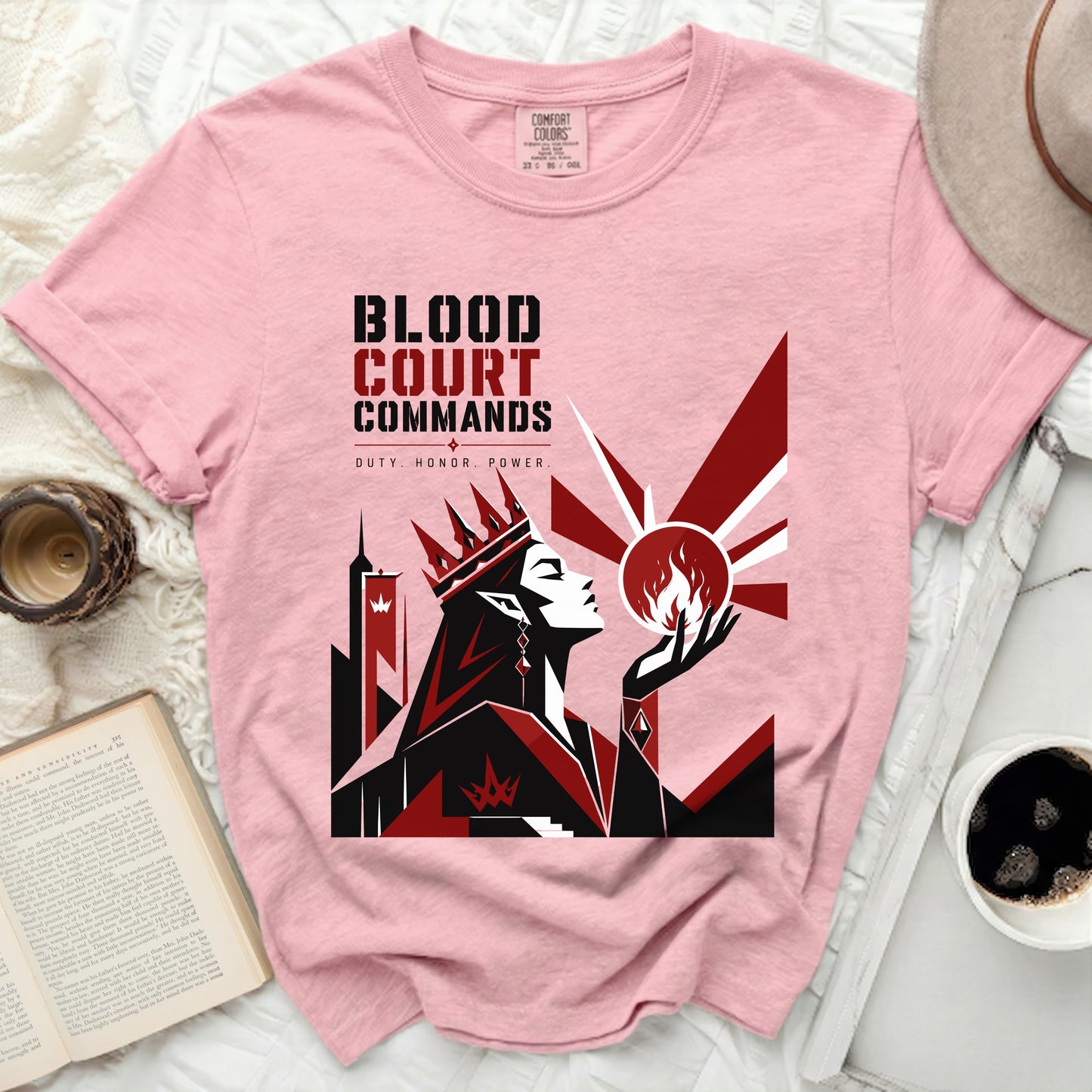 Pink t-shirt with "Blood Court Commands" graphic and a crown queen figure.