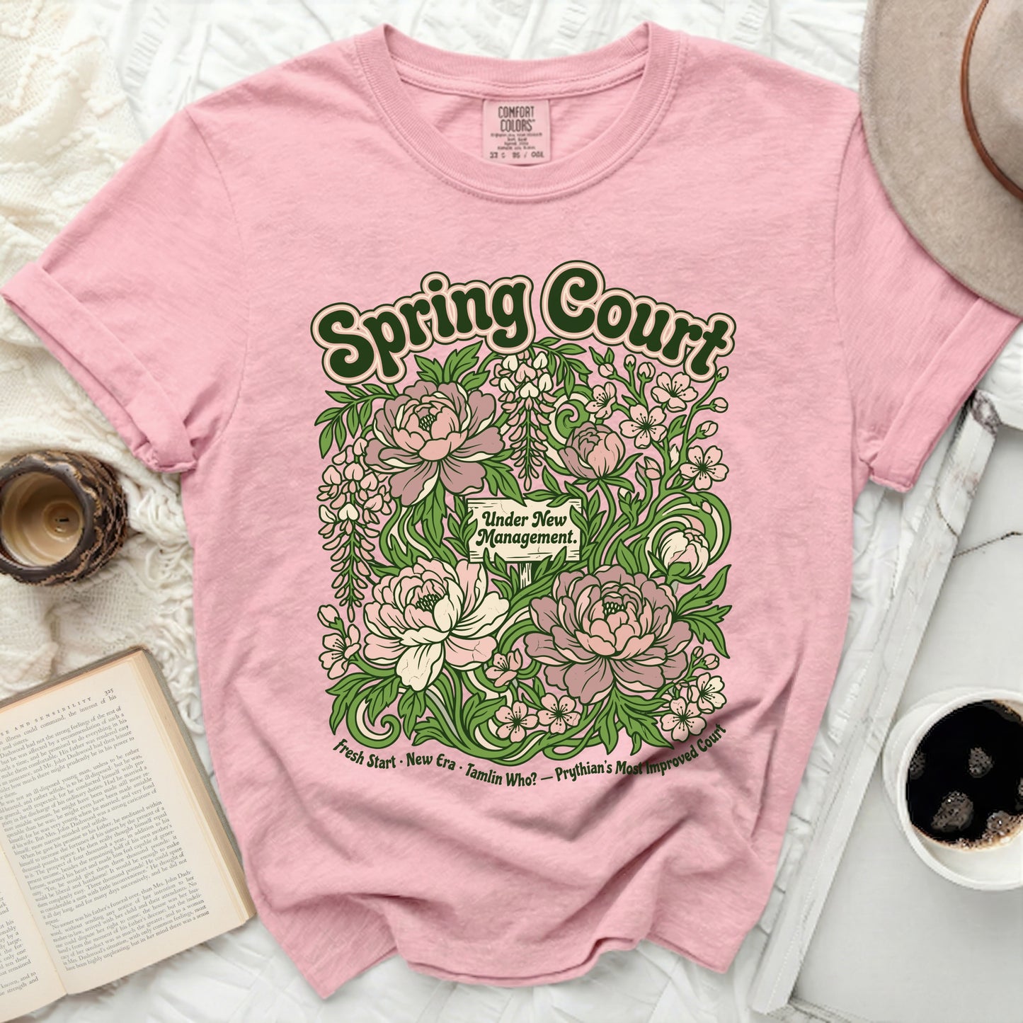 Pink t-shirt with "Spring Court Under New Management" floral design.