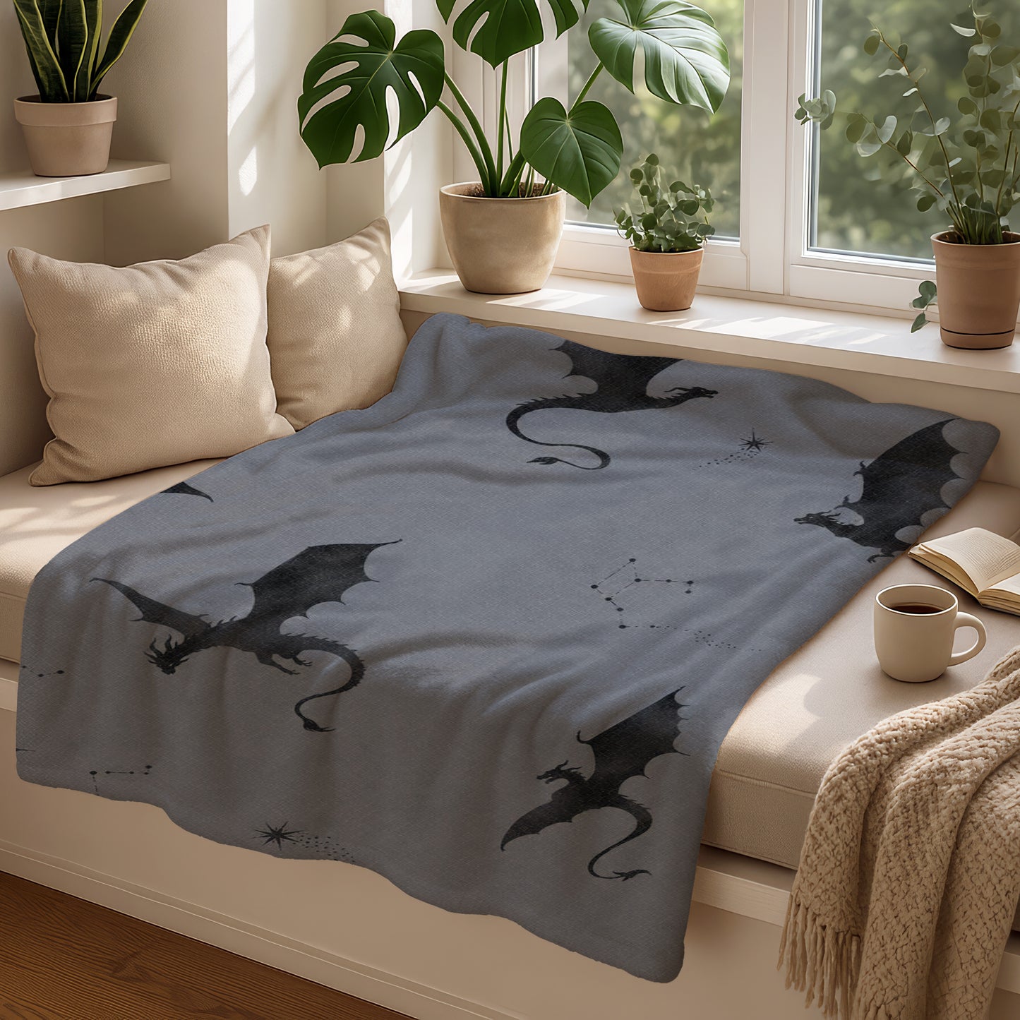 Grey blanket with scattered black dragons and constellation patterns.