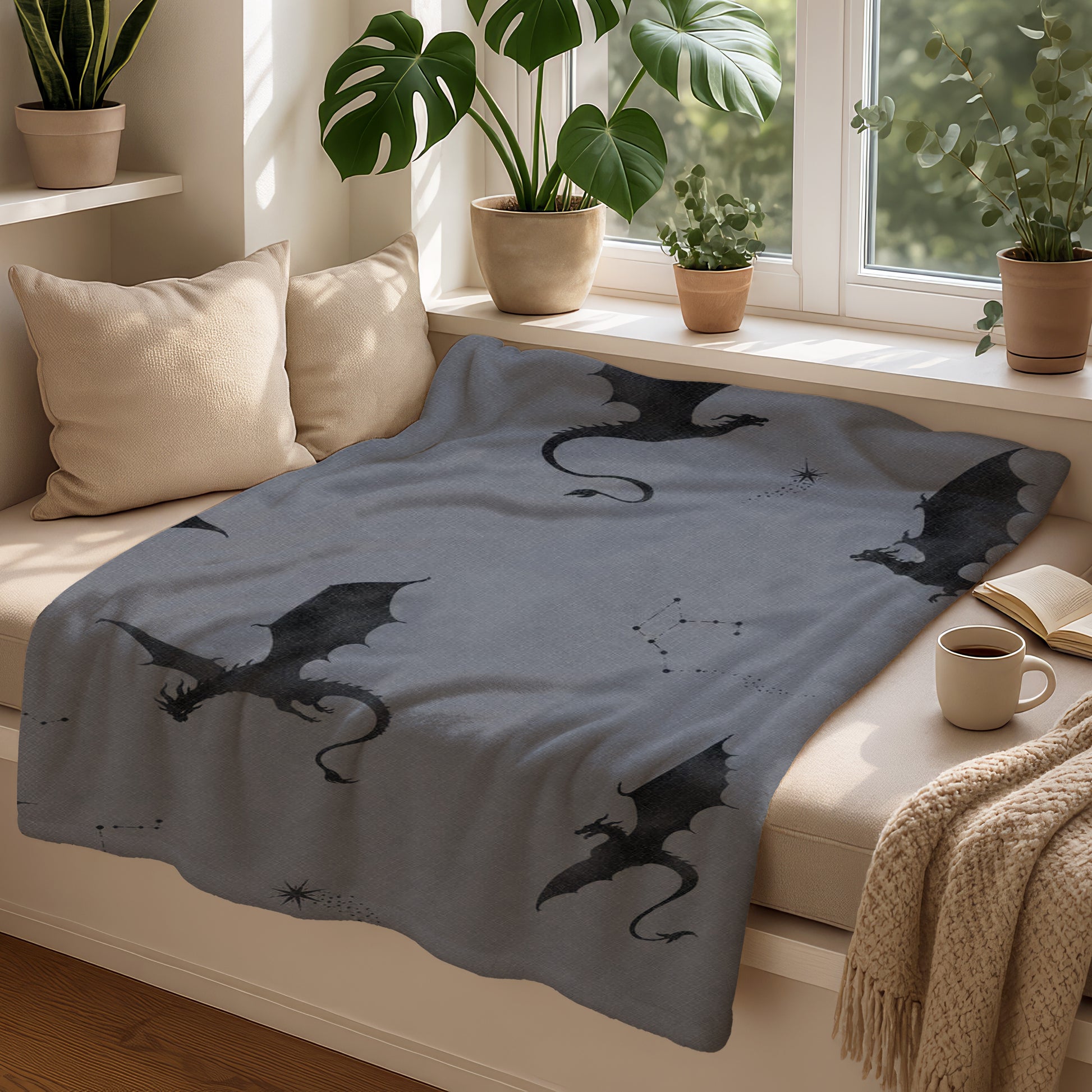 Grey blanket with scattered black dragons and constellation patterns.