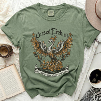 Green t-shirt with a "Cursed Firebird" graphic and text "Vassa - Queen - Bound at Dusk - Free at Dawn".