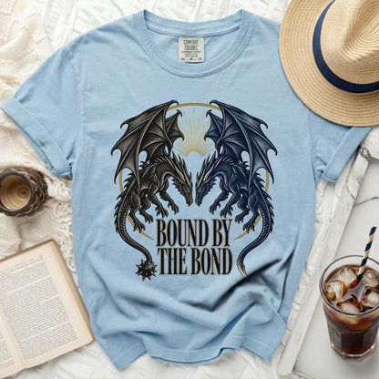 Light blue t-shirt with black and dark blue dragons and text "BOUND BY THE BOND".