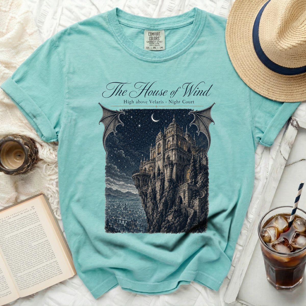 Teal t-shirt with "The House of Wind" and castle graphic.