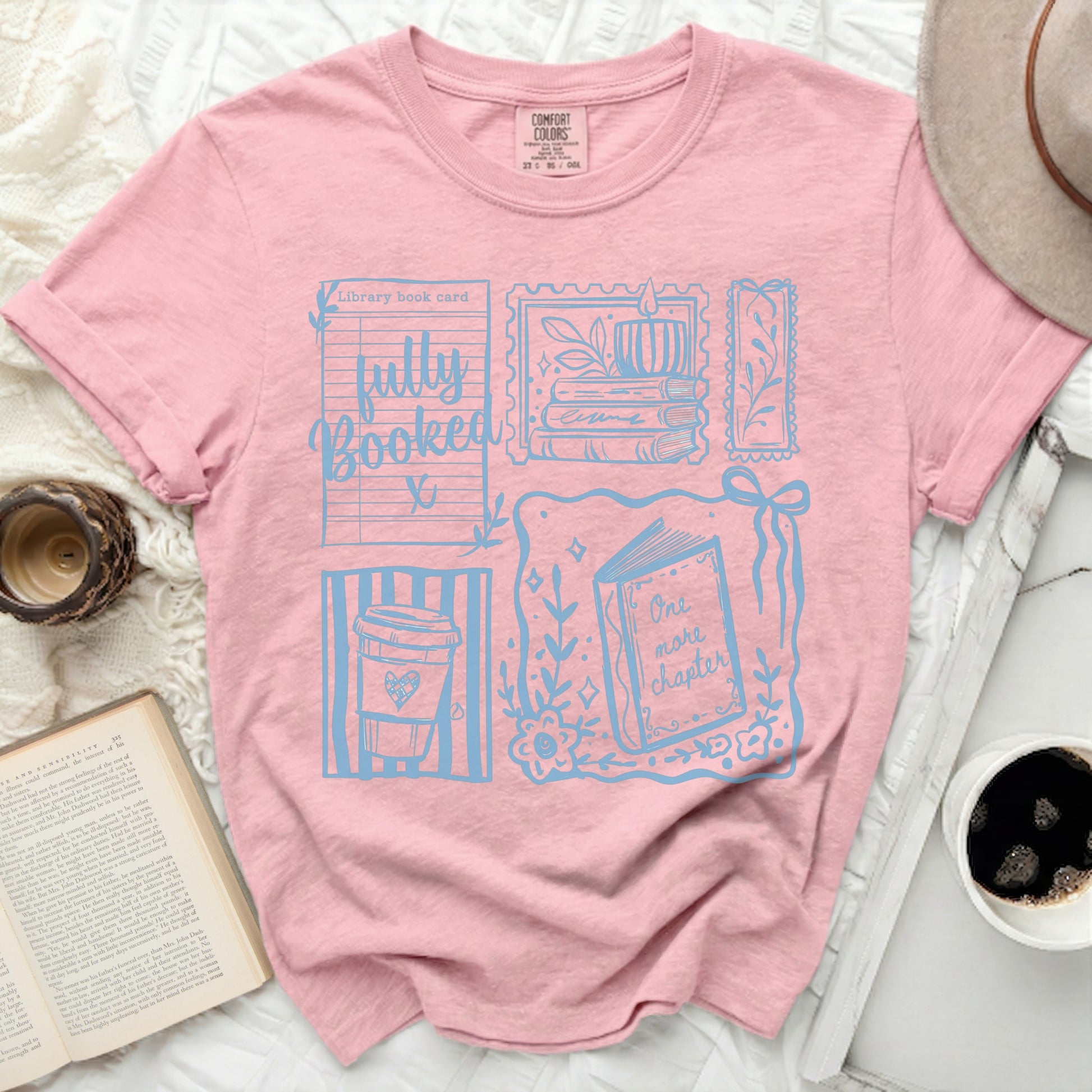 Pink t-shirt with "Fully Booked" and book-themed graphics.