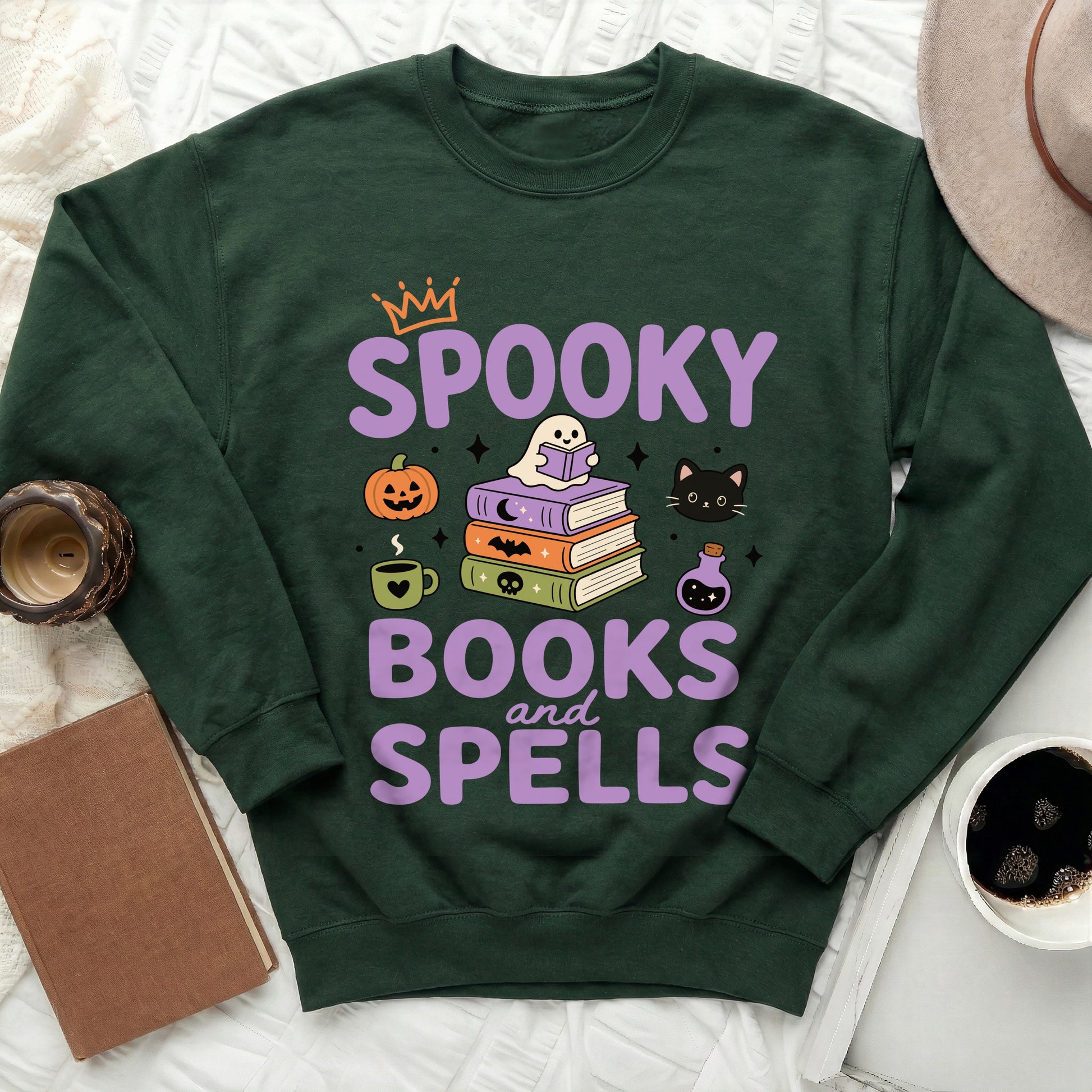 Green sweatshirt with "Spooky Books and Spells" in purple text and Halloween graphics.