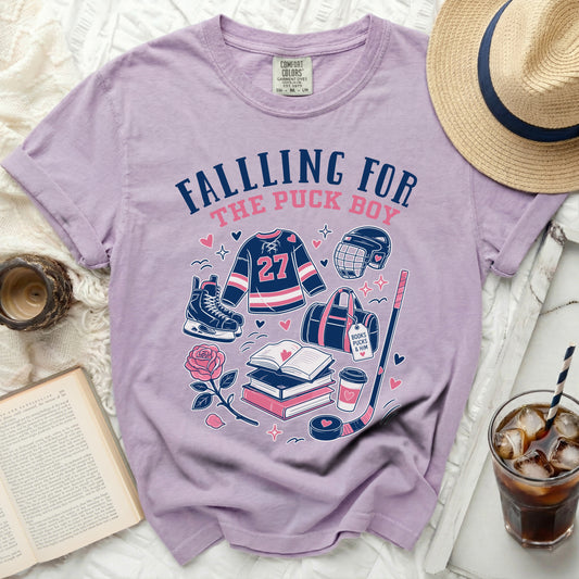 Lilac t-shirt with hockey and rose graphics, "Falling For The Puck Boy" text.