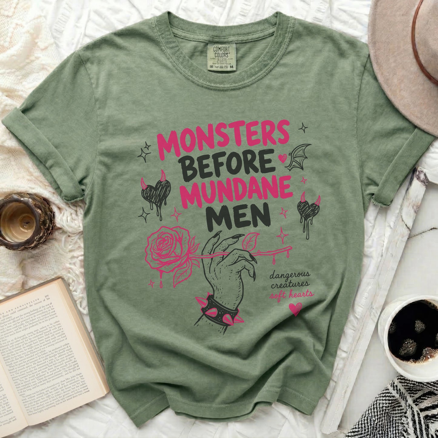 Green t-shirt with "Monsters Before Mundane Men" text and rose design.