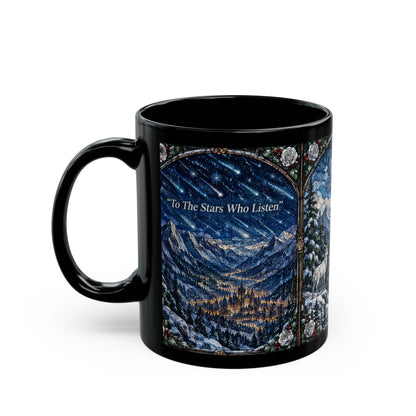 A black ceramic mug printed with a fantasy mountain landscape under a starry sky and the text "To The Stars Who Listen".