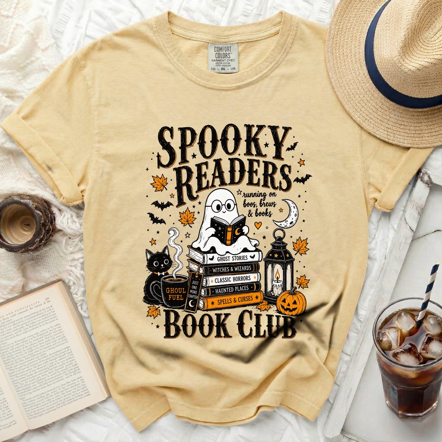 Yellow t-shirt with "Spooky Readers Book Club" graphic featuring a ghost, books, black cat, and Halloween elements.