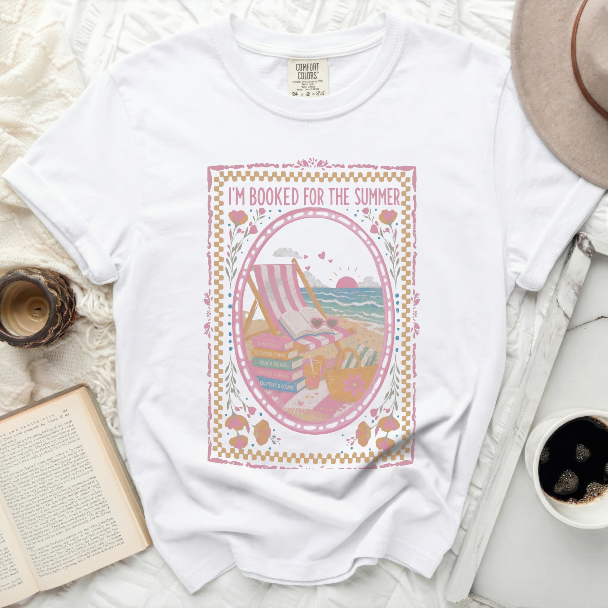 White t-shirt with "I'm Booked for the Summer" slogan and beach scene graphic.