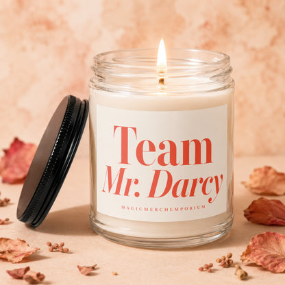 Jar candle with a lit wick, labeled "Team Mr. Darcy" and "MAGICMERCHEMPORIUM".
