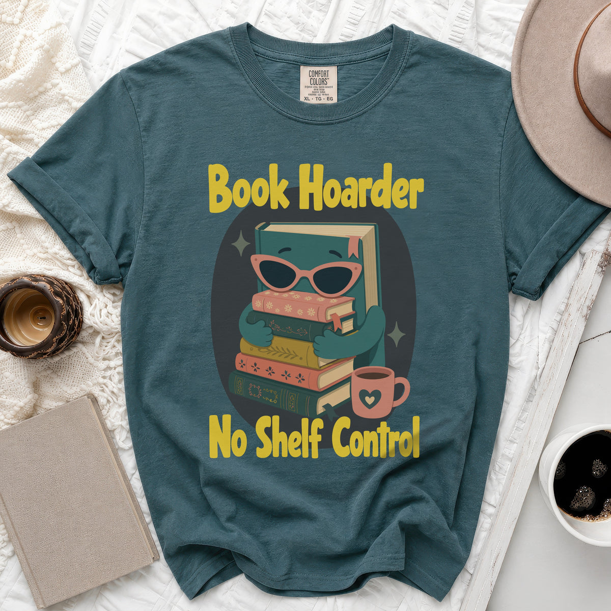 Teal t-shirt with graphic "Book Hoarder No Shelf Control" and stack of books.