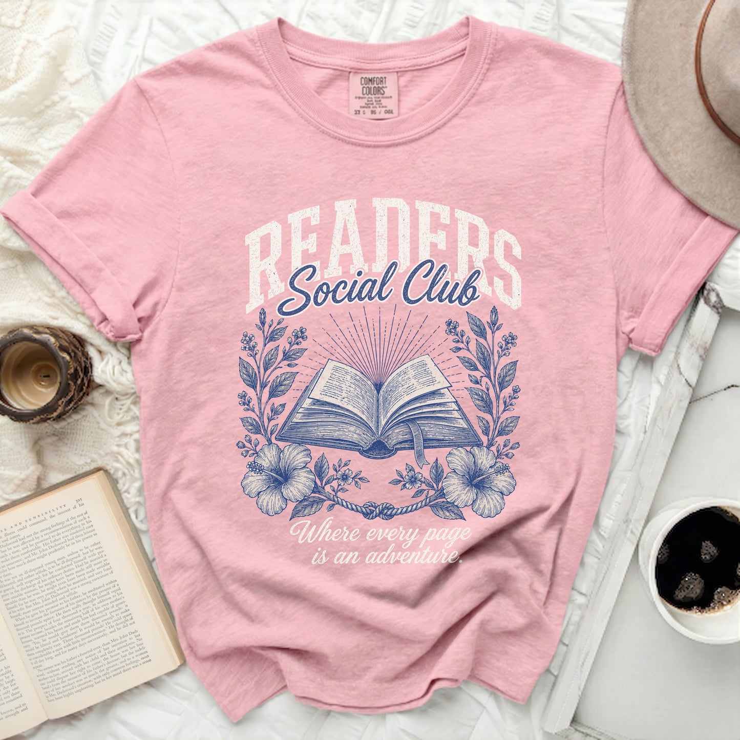 Pink t-shirt with "Readers Social Club" and an open book design.