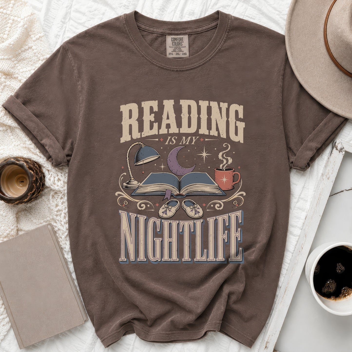 Brown t-shirt with "Reading is my nightlife" graphic and book, moon, and coffee cup.