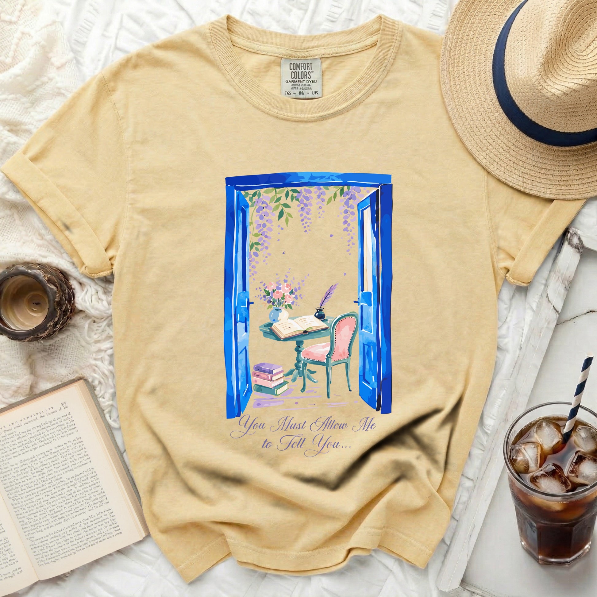 Yellow t-shirt with a blue doorway, flowers, and text "You Must Allow Me to Tell You...".