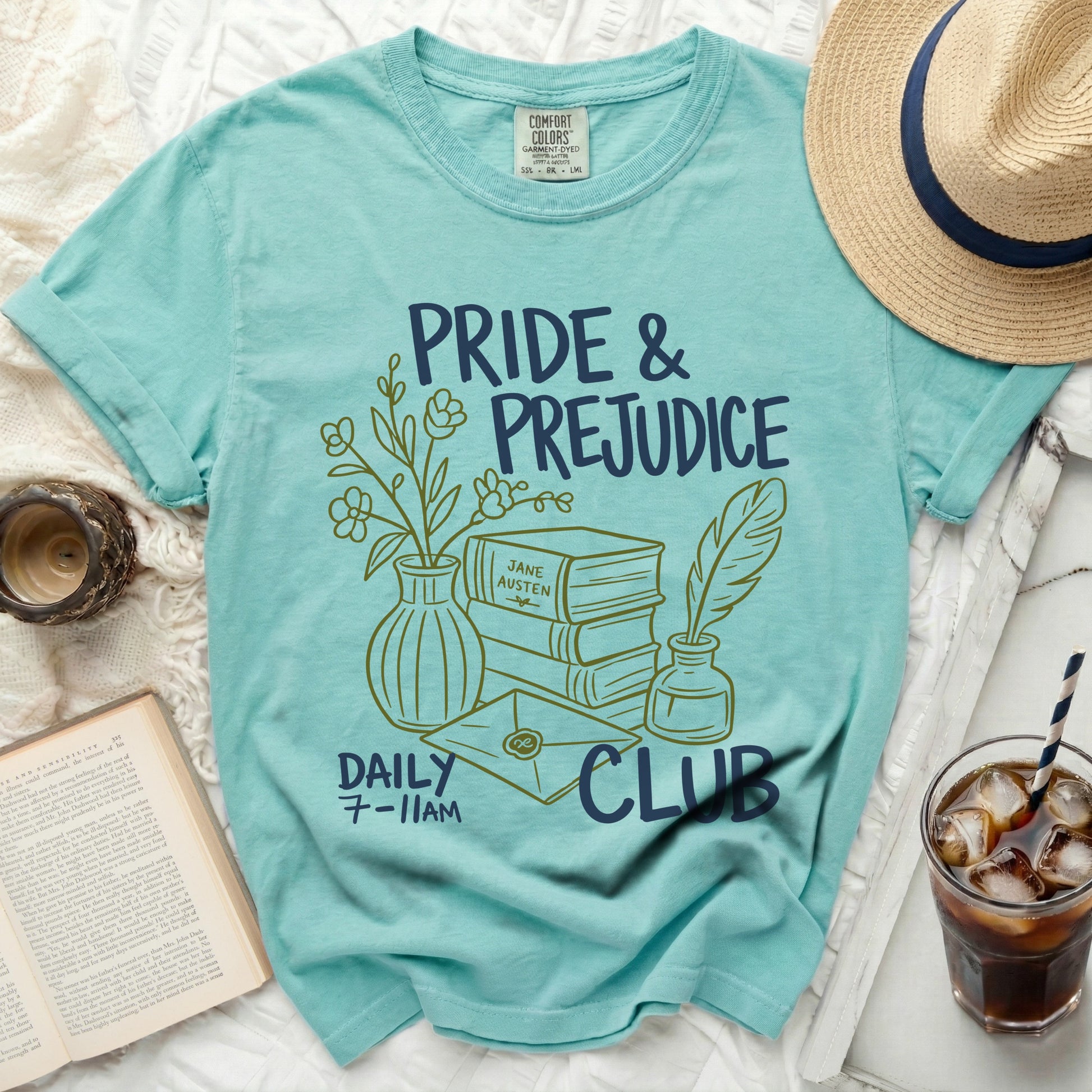 Turquoise t-shirt with "Pride & Prejudice Daily Club" graphics and book imagery.