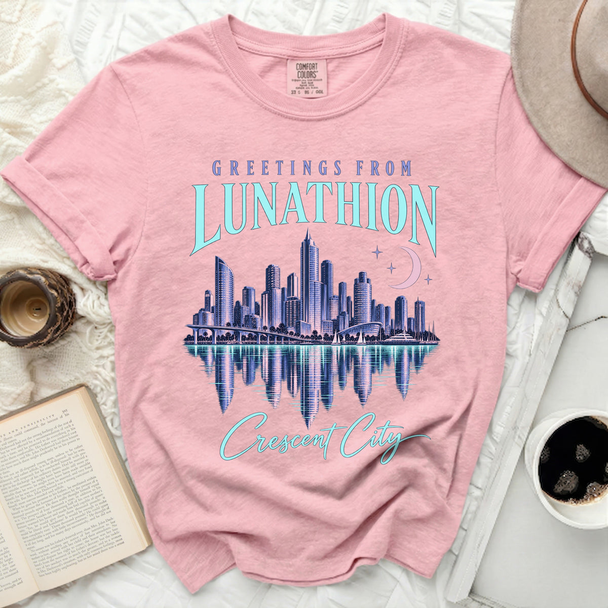 Pink t-shirt with "Greetings from Lunathion Crescent City" graphic and city skyline.