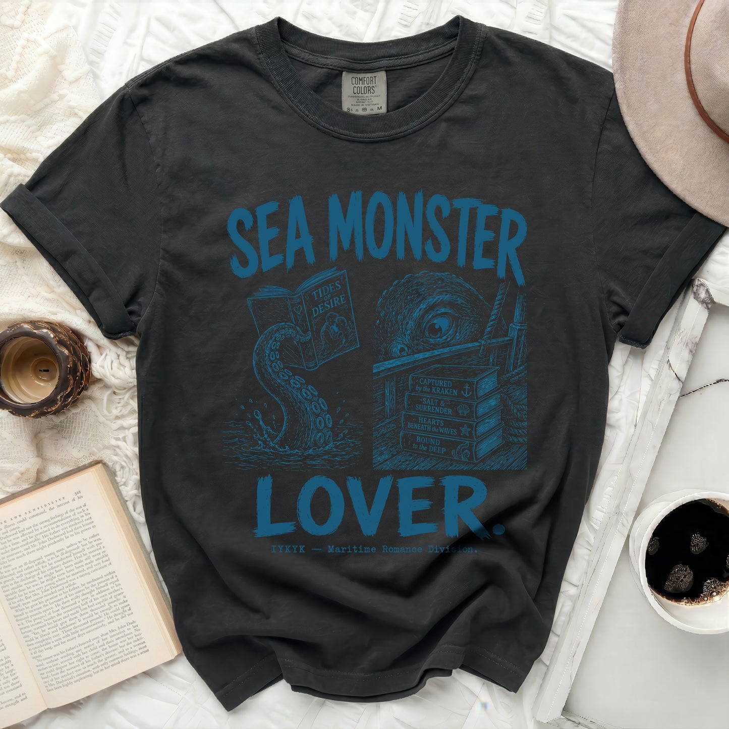 Dark t-shirt with blue "Sea Monster Lover" graphic featuring books and kraken tentacles.
