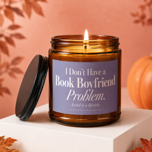 A lit amber glass jar candle with a purple label resting on a white pedestal.