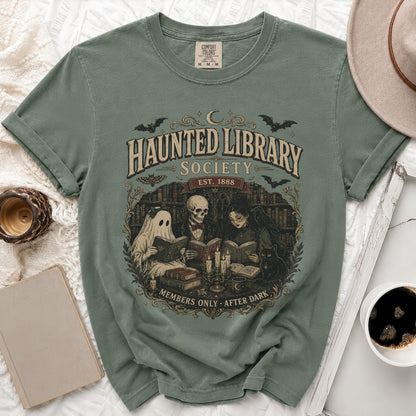 Green t-shirt with "Haunted Library Society Est. 1888 Members Only After Dark" graphic.