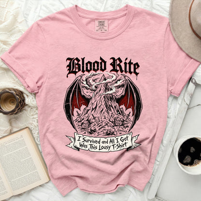 Pink t-shirt with "Blood Rite" and a mountain scene with swords, skulls, and text.
