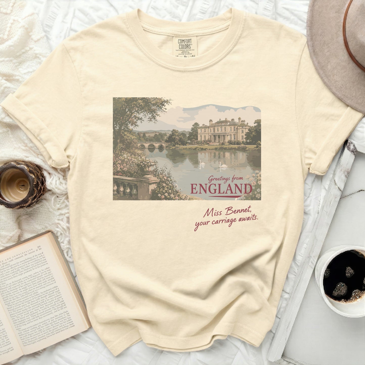 Cream t-shirt with "Greetings from England Miss Bennet, your carriage awaits." text.