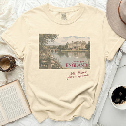 Cream t-shirt with "Greetings from England Miss Bennet, your carriage awaits." text.