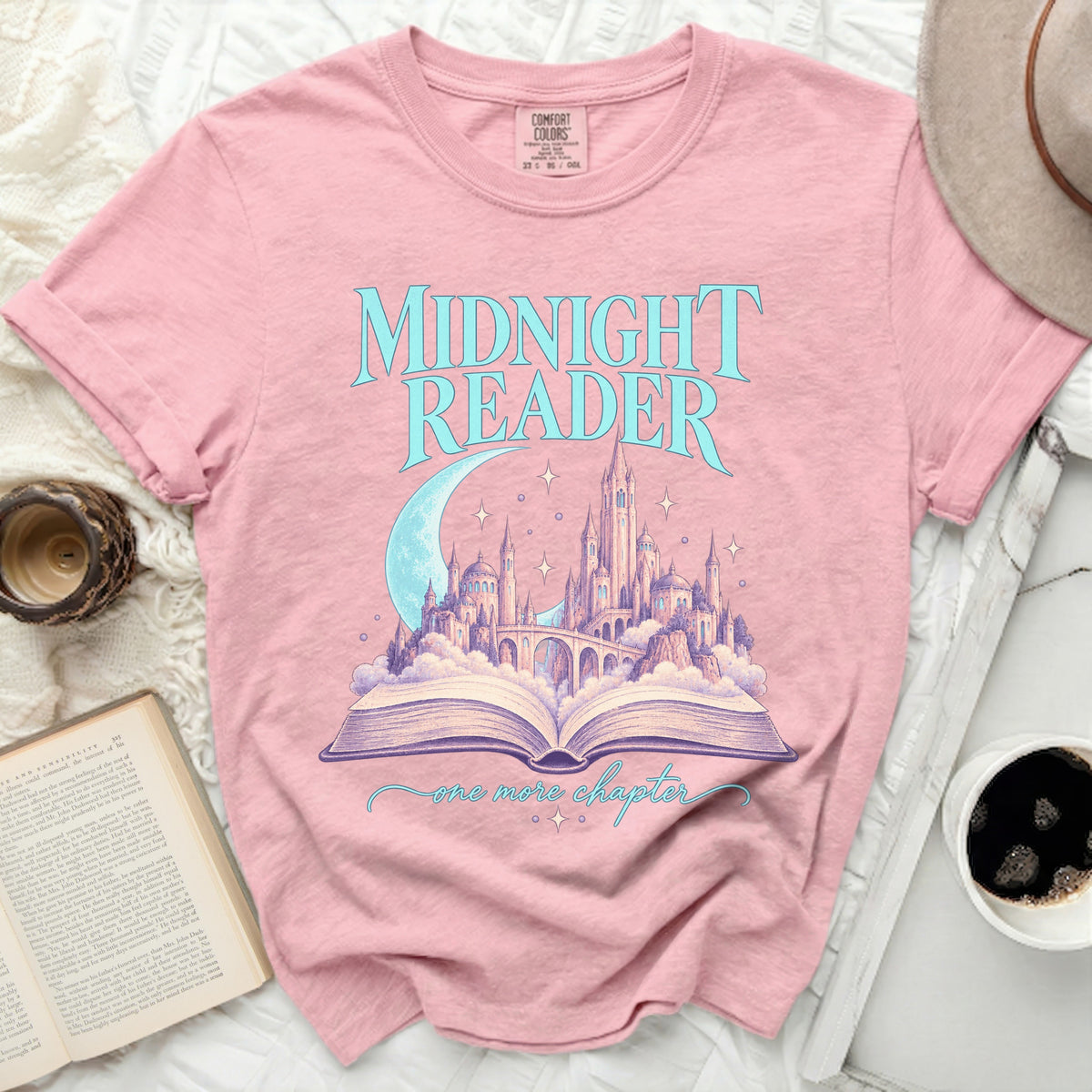 Pink t-shirt with "Midnight Reader" text and a castle on an open book.
