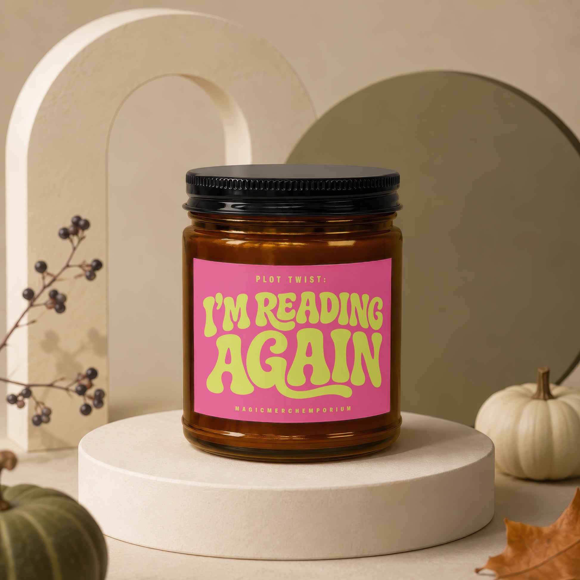 Amber jar candle with pink label saying "PLOT TWIST: I'M READING AGAIN".