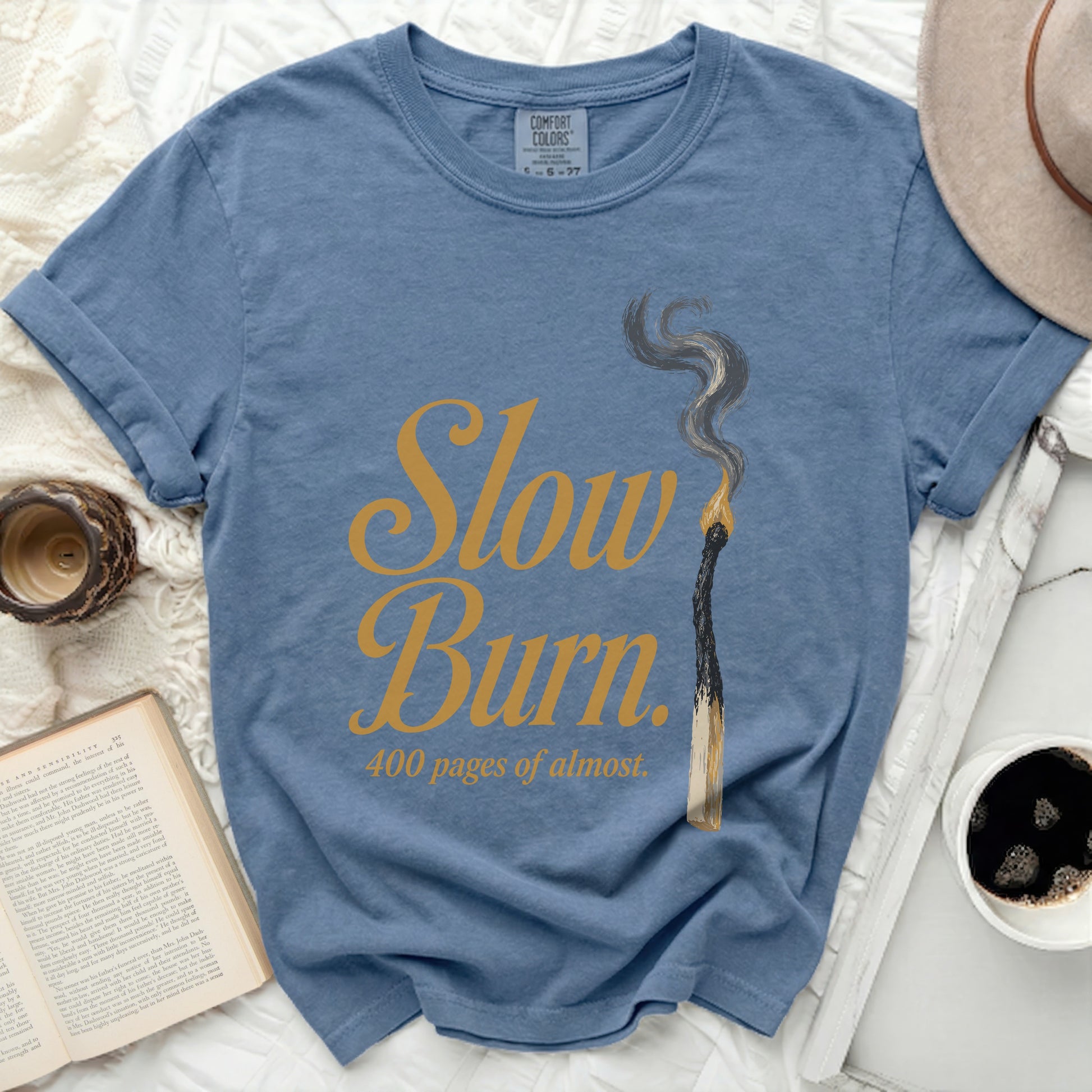 Blue t-shirt with "Slow Burn, 400 pages of almost" text.