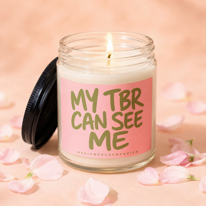 Jar candle with lit wick and pink label reading "MY TBR CAN SEE ME".
