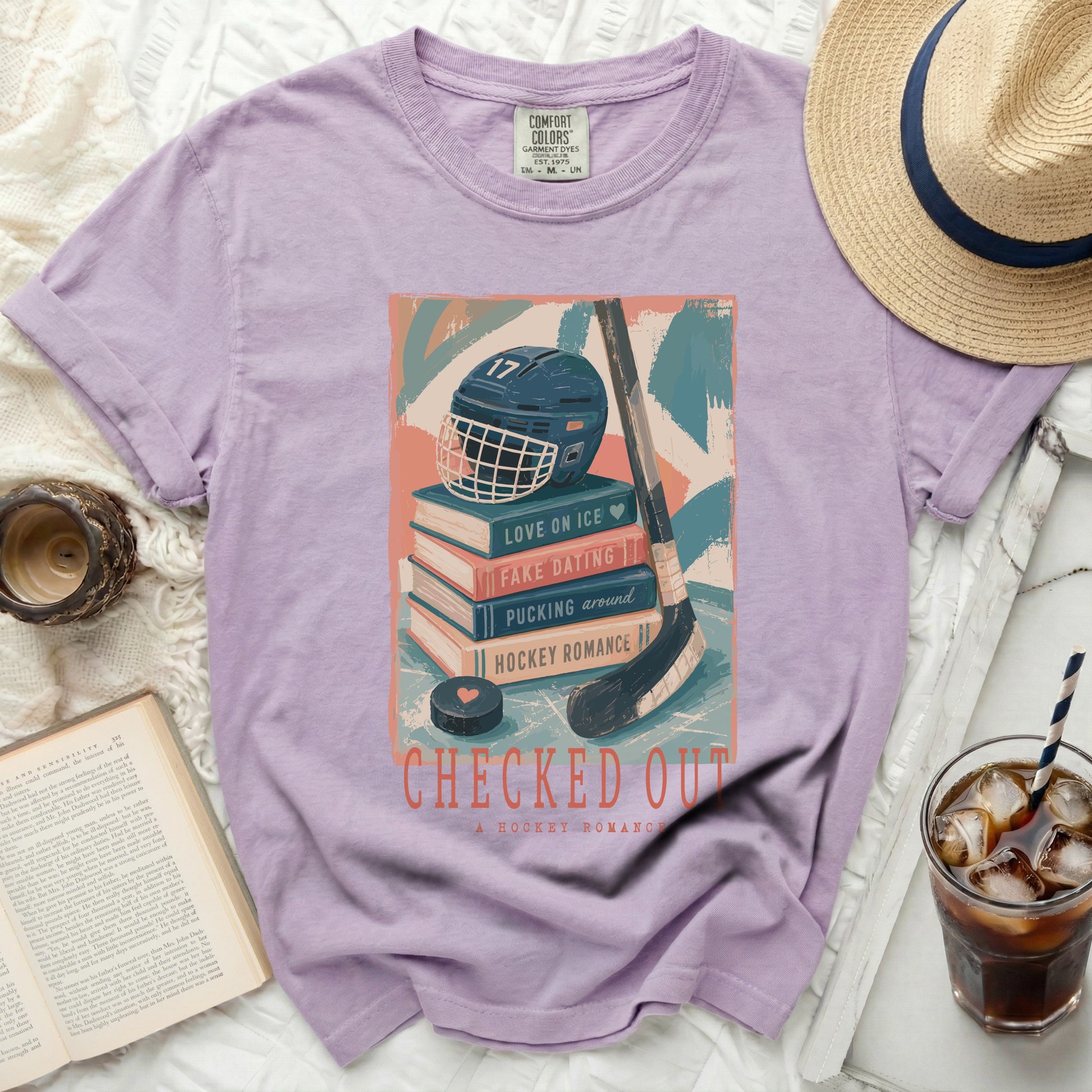Graphic tee with hockey helmet, books, and "Checked Out" title.