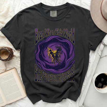 Black t-shirt with purple cosmic art and text "Even When This World Is A Forgotten Whisper of Dust Between The Stars."