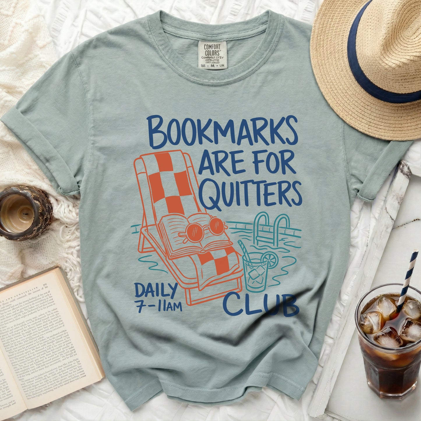 "Bookmarks Are For Quitters" graphic tee with books, pool, and chair.
