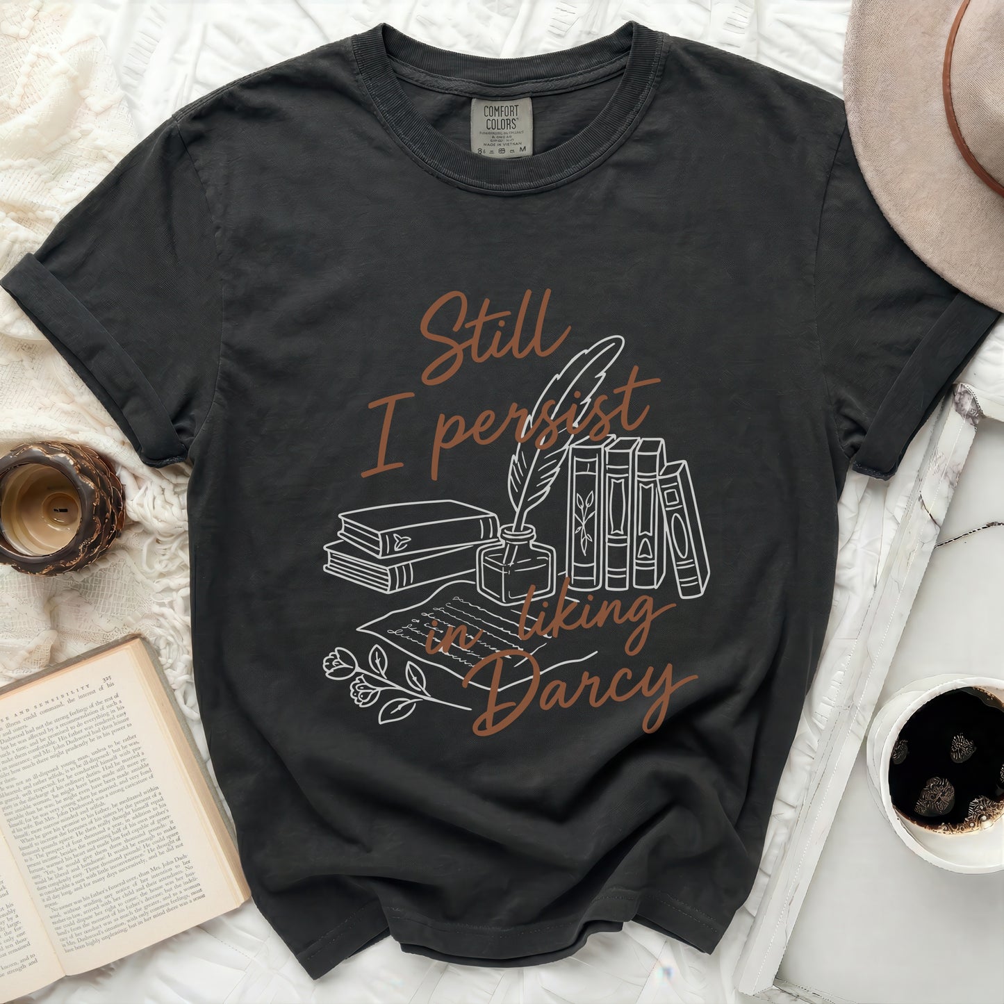 Black Comfort Colors t-shirt with "Still I persist in liking Darcy" text and illustrations.