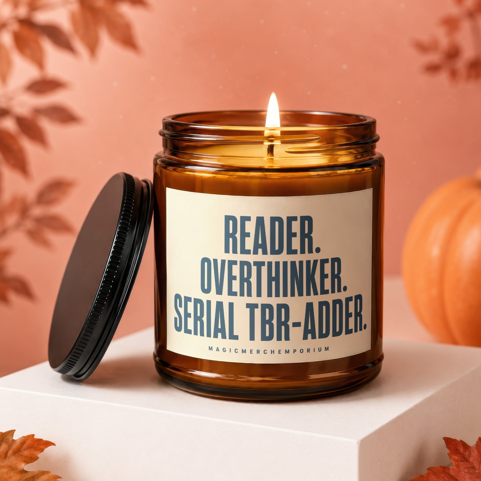 Amber jar candle with text "READER. OVERTHINKER. SERIAL TBR-ADDER."