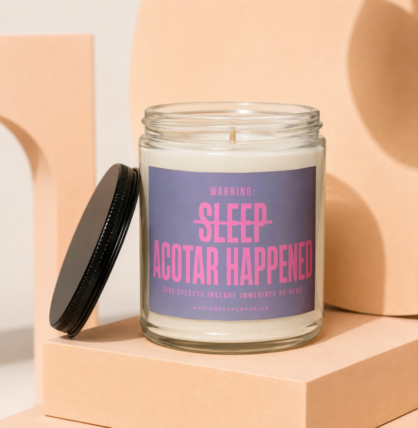 Candle with "WARNING: SLEEP ACOTR HAPPENED" text in pink on purple label.