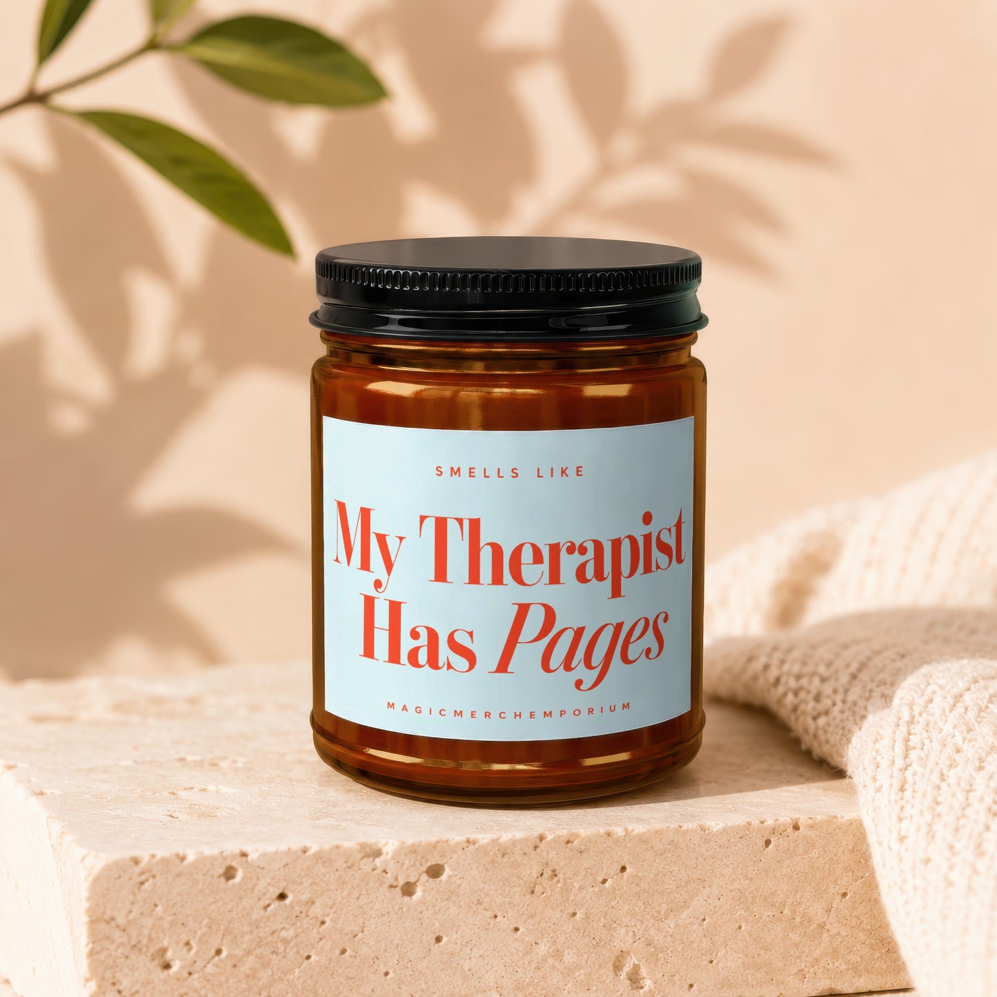 Amber candle labeled "My Therapist Has Pages" with a black lid.
