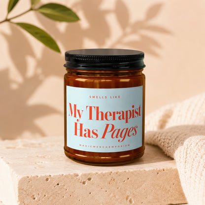 Amber candle labeled "My Therapist Has Pages" with a black lid.