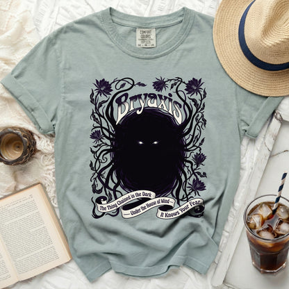 Bryaxis t-shirt with dark floral design and text: The Thing Chained in the Dark.