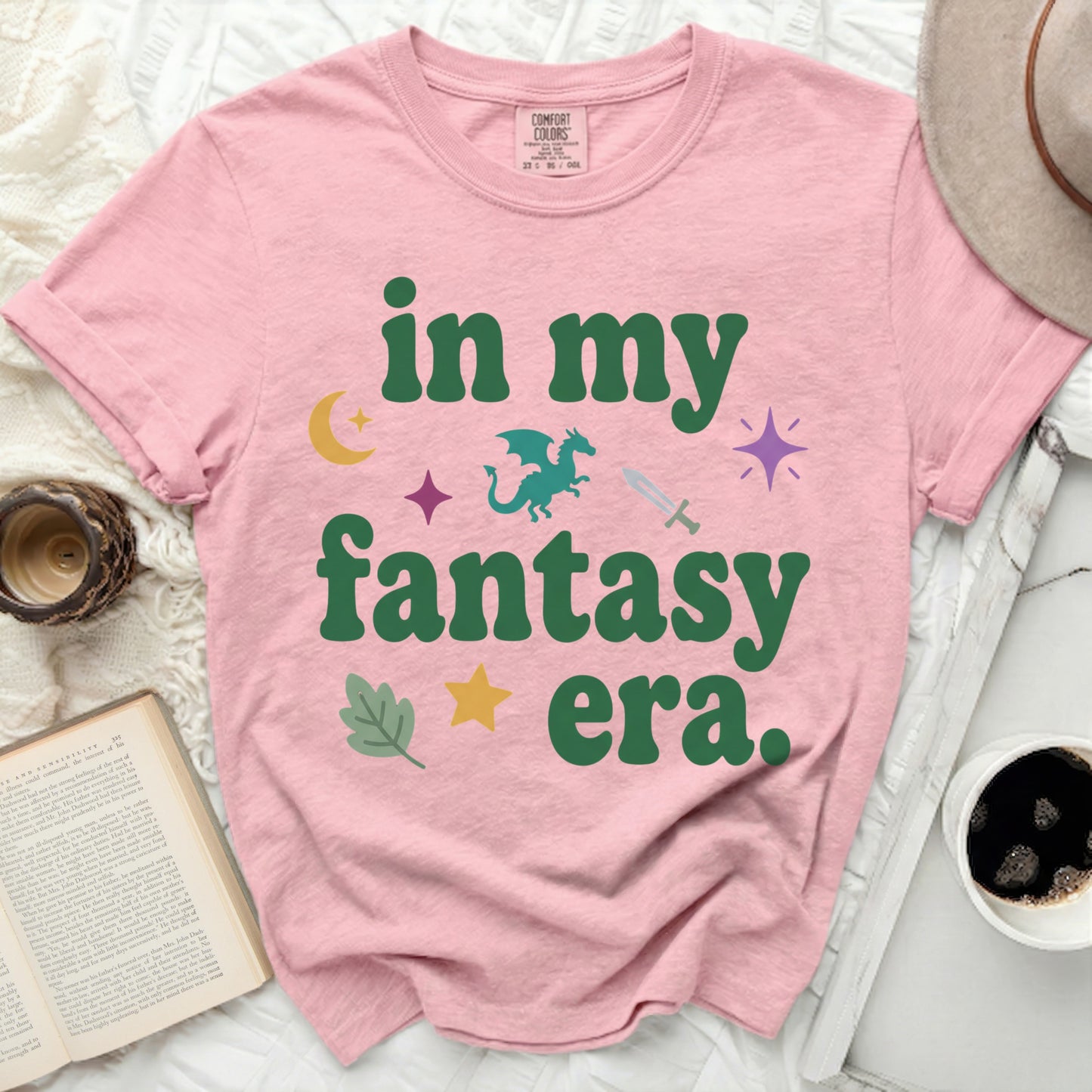 Pink t-shirt with "in my fantasy era" text and fantasy icons.