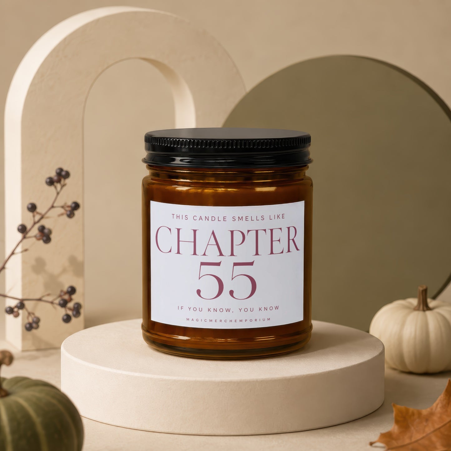 Amber candle labeled "Chapter 55 If You Know, You Know" displayed with decorative pumpkins.