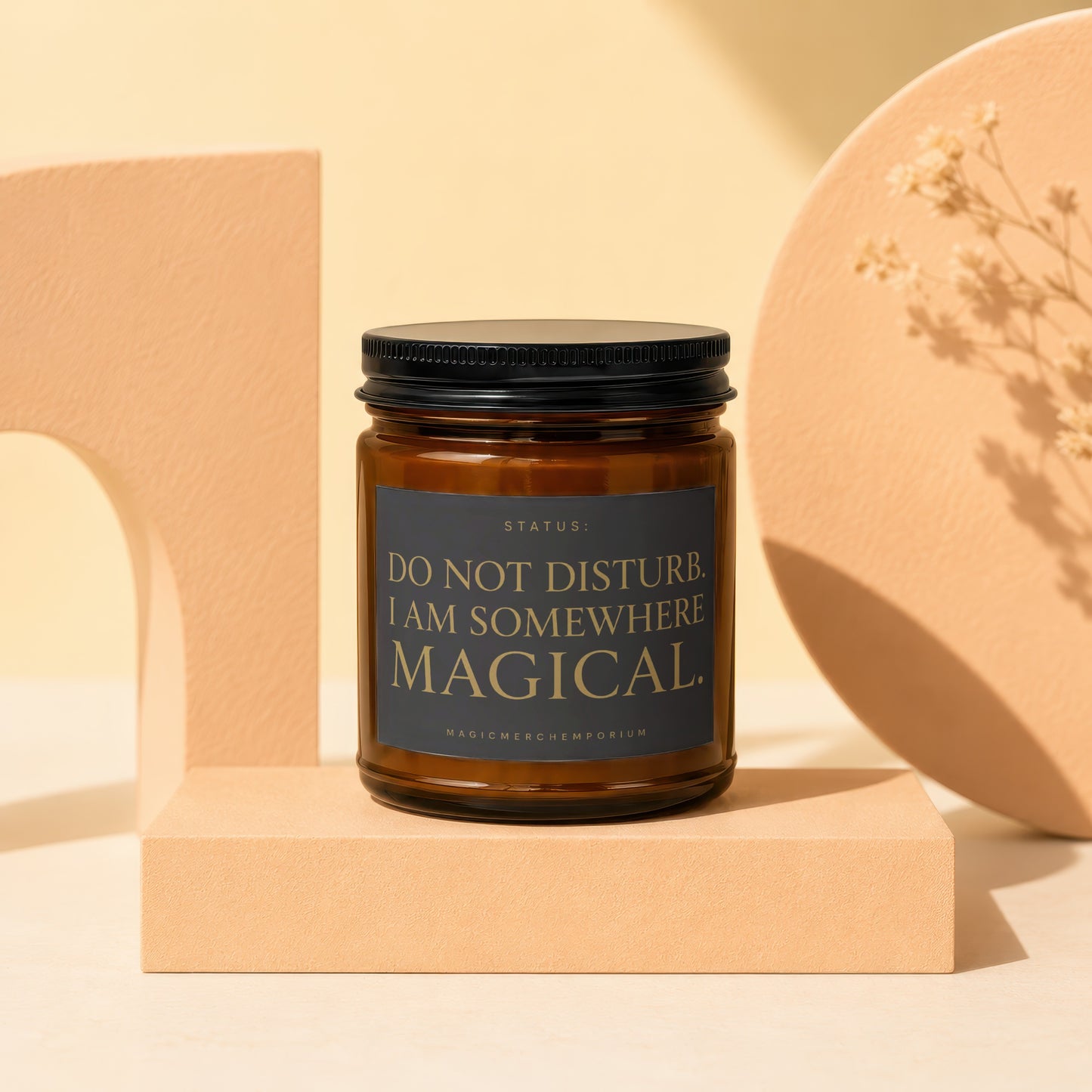 Amber candle with black lid and label that reads "Do Not Disturb. I Am Somewhere Magical."