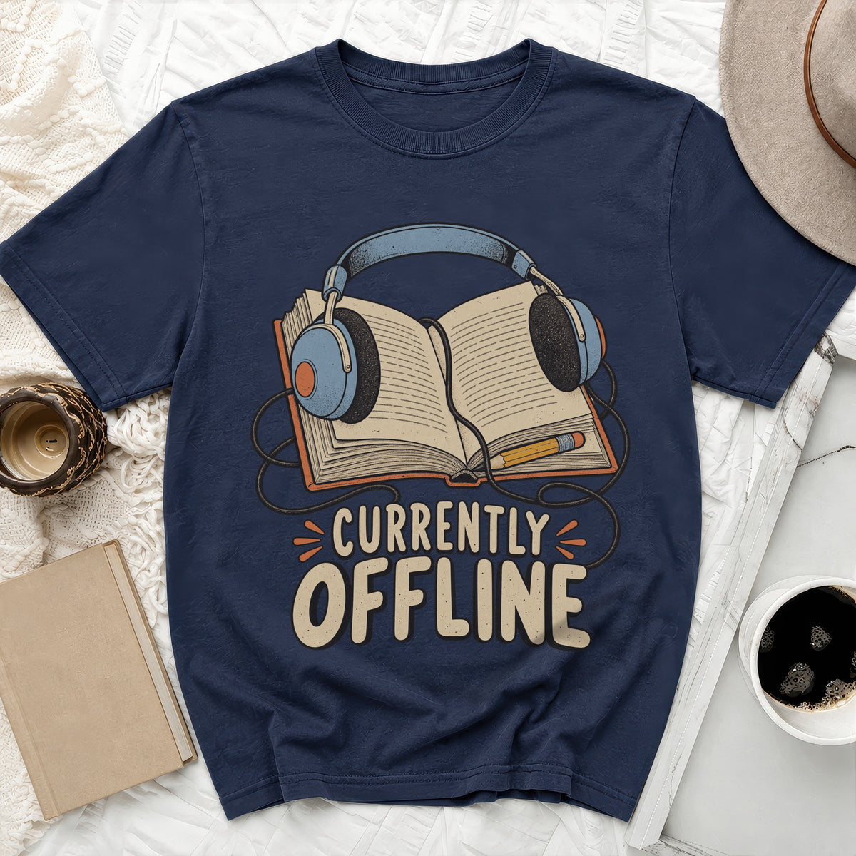 Navy t-shirt with headphones on an open book, reading "Currently Offline".