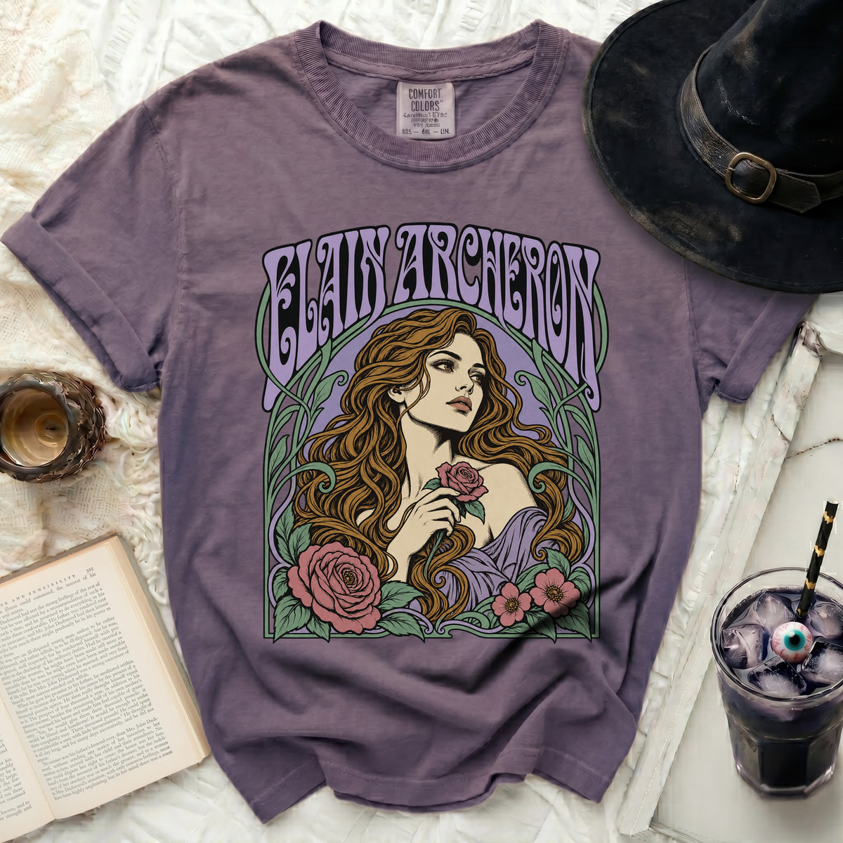 Purple t-shirt with Elaine Archeron and floral art, Comfort Colors tag.