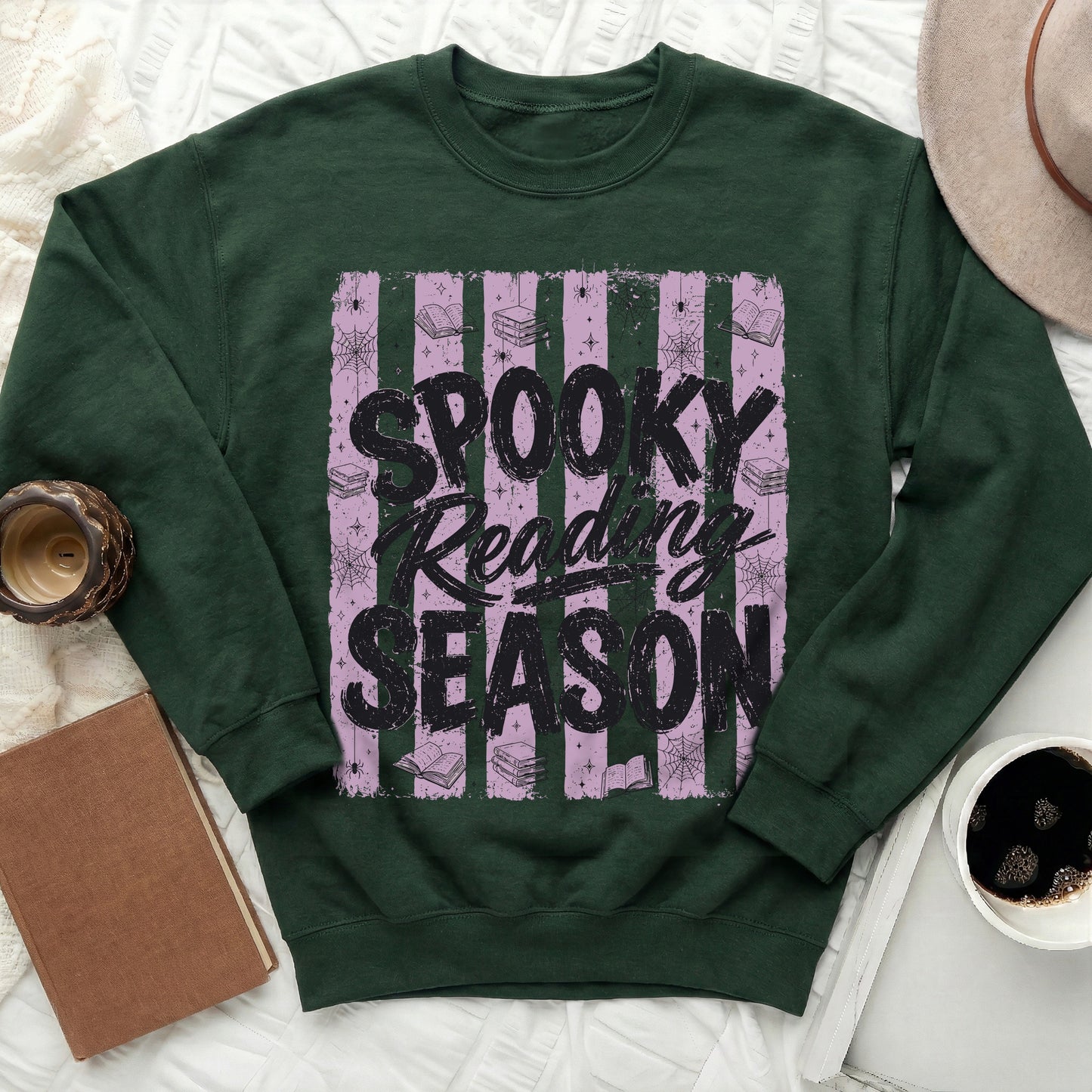 Dark green sweatshirt with "Spooky Reading Season" text and Halloween-themed graphics.