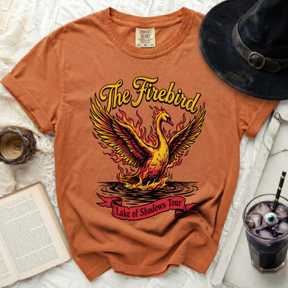 Orange t-shirt with a graphic of The Firebird "Lake of Shadows Tour"