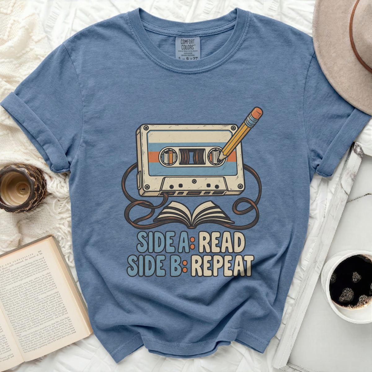Cassette tape with pencil and book graphic; "SIDE A: READ SIDE B: REPEAT" text.